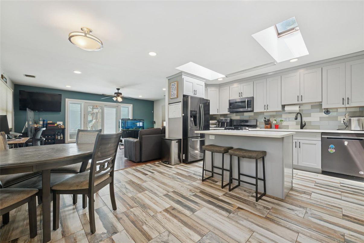 Dining room, Interior, Kitchen, Living room, Recessed Lighting, Stainless Steel Appliances, Wood Texture Flooring