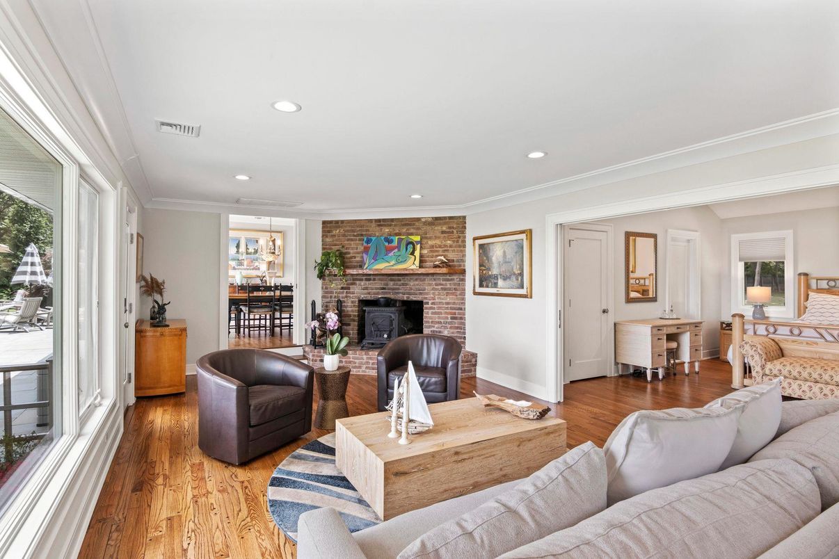Dining room, Fireplace, Interior, Living room, Recessed Lighting, Stone Walls, Wood Texture Flooring