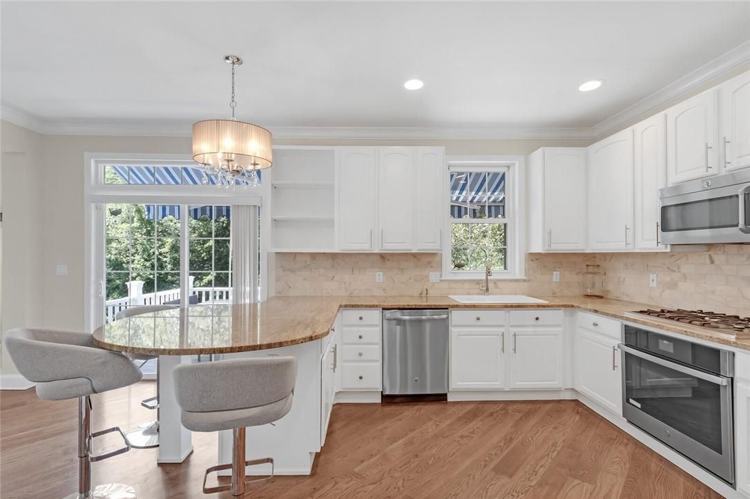 Chandelier, Dining room, Interior, Kitchen, Pendant Lights, Recessed Lighting, Stainless Steel Appliances, Wood Texture Flooring