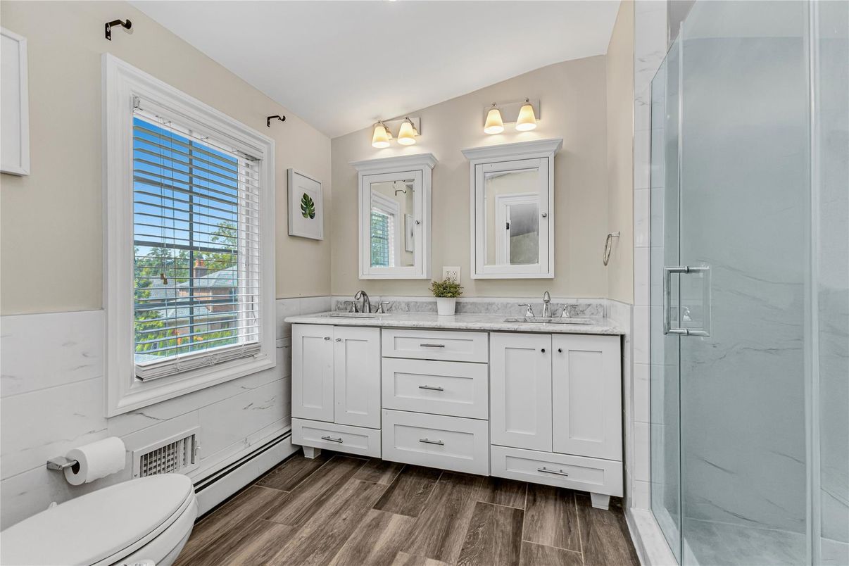 Bathroom, Dual Sink Vanities, Glass Shower, Interior, Marble Walls, Wood Texture Flooring