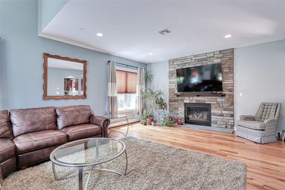 Fireplace, Interior, Living room, Recessed Lighting, Stone Walls, Wood Texture Flooring