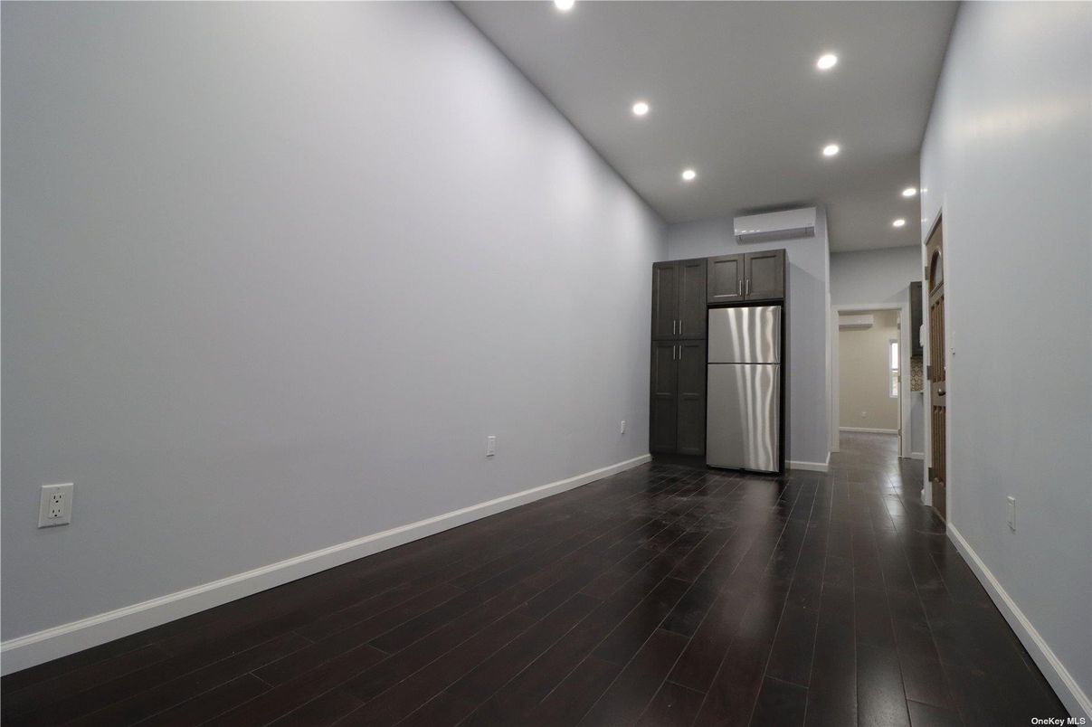 Empty room, Interior, Kitchen, Recessed Lighting, Stainless Steel Appliances, Wood Texture Flooring