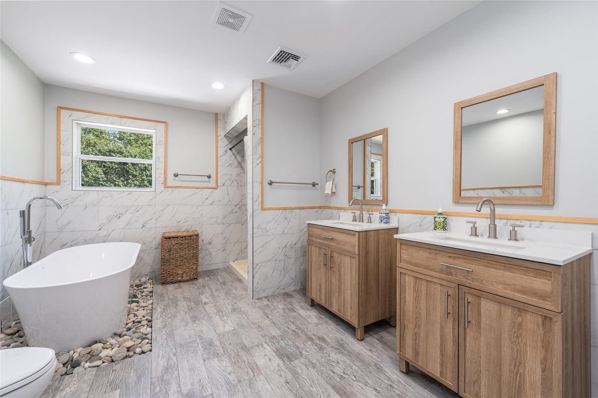 Bathroom, Dual Sink Vanities, Free Standing Baths, Interior, Marble Walls, Recessed Lighting, Wood Texture Flooring
