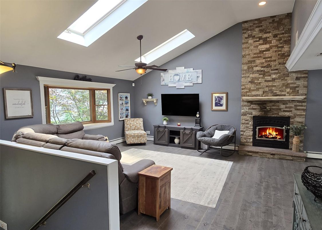 Fireplace, Interior, Living room, Recessed Lighting, Stone Walls, Wood Texture Flooring