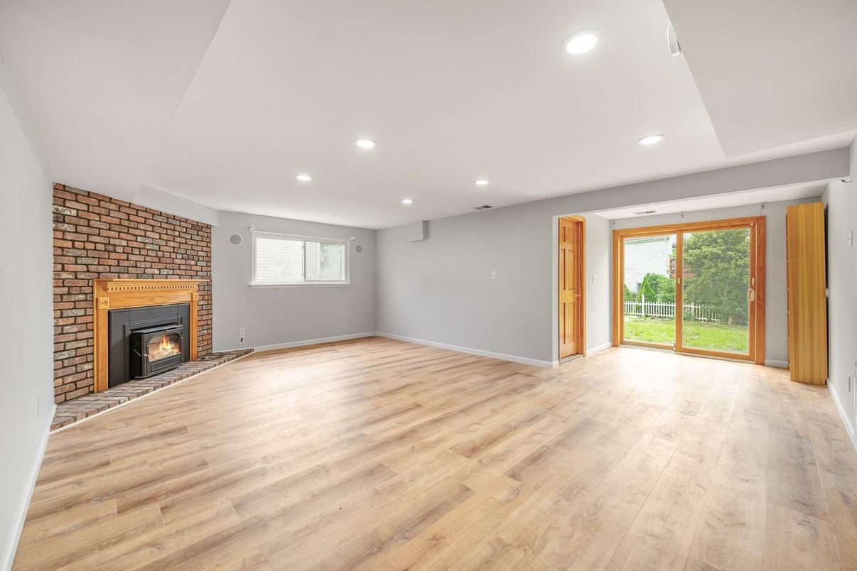 Empty room, Fireplace, Interior, Recessed Lighting, Stone Walls, Wood Texture Flooring