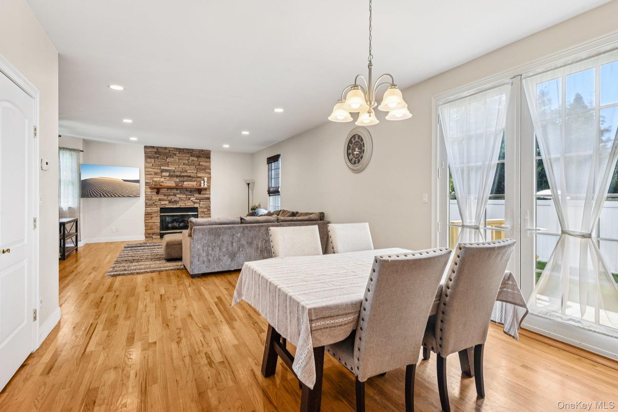 Dining room, Fireplace, Interior, Living room, Pendant Lights, Recessed Lighting, Wood Texture Flooring
