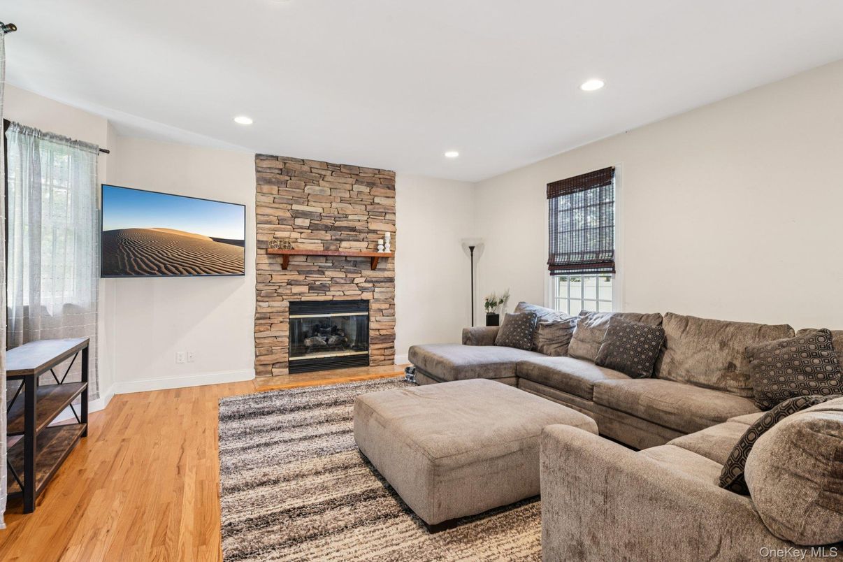 Fireplace, Interior, Living room, Recessed Lighting, Stone Walls, Wood Texture Flooring
