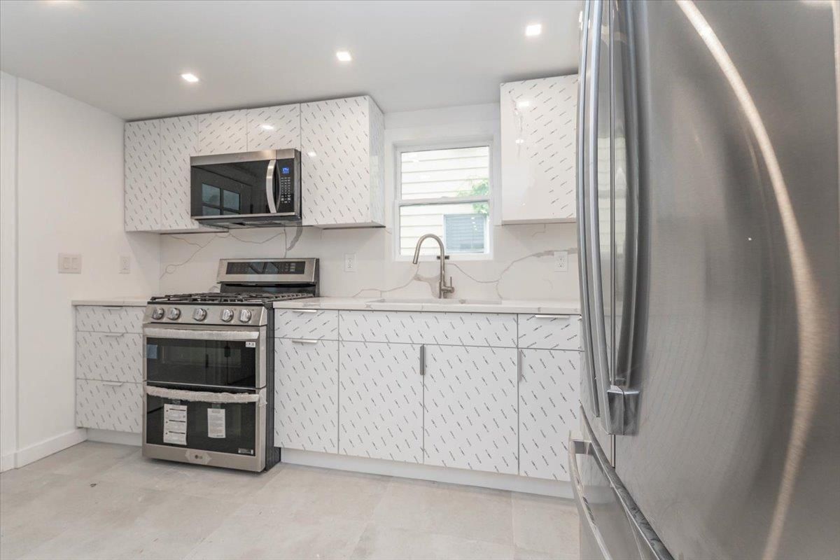 Interior, Kitchen, Marble Walls, Recessed Lighting, Stainless Steel Appliances