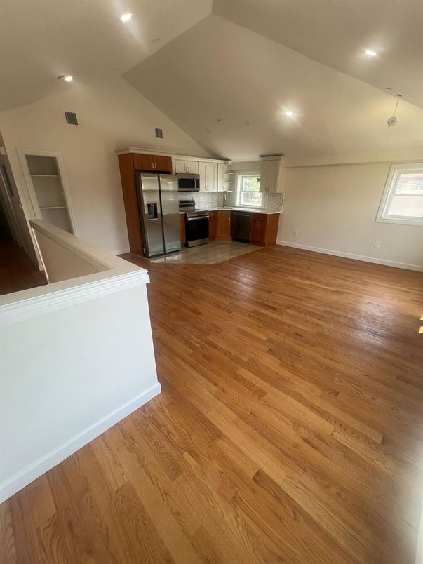 Empty room, Interior, Kitchen, Recessed Lighting, Stainless Steel Appliances, Wood Texture Flooring