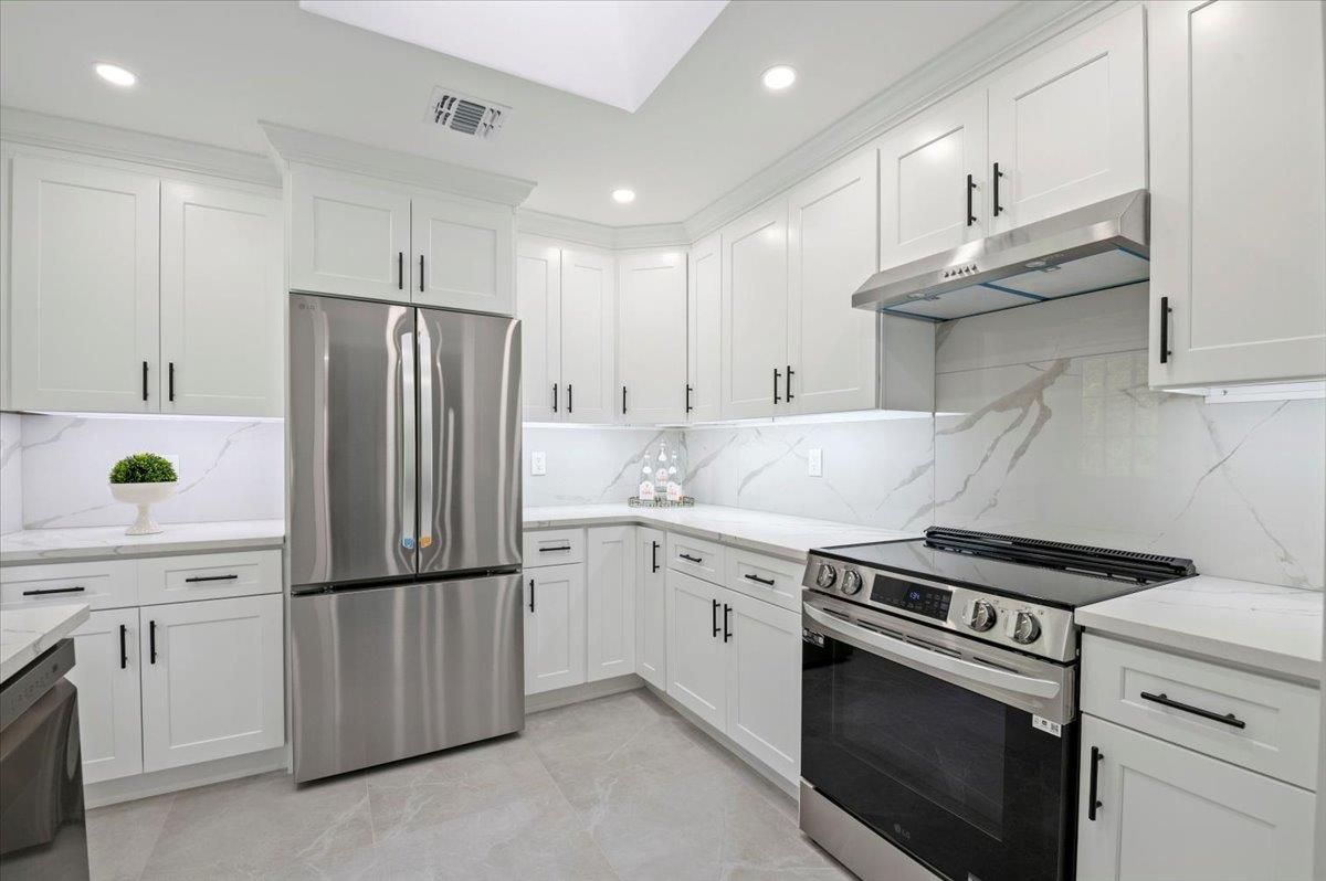 Interior, Kitchen, Marble Walls, Recessed Lighting, Stainless Steel Appliances