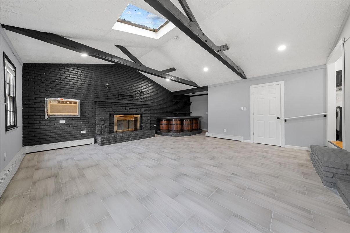 Empty room, Fireplace, Interior, Recessed Lighting, Stone Walls, Wooden Beams, Wood Texture Flooring