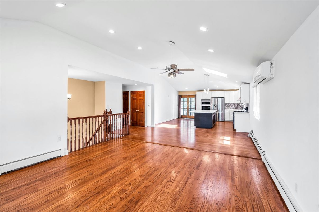 Empty room, Interior, Kitchen, Recessed Lighting, Stainless Steel Appliances, Wood Texture Flooring
