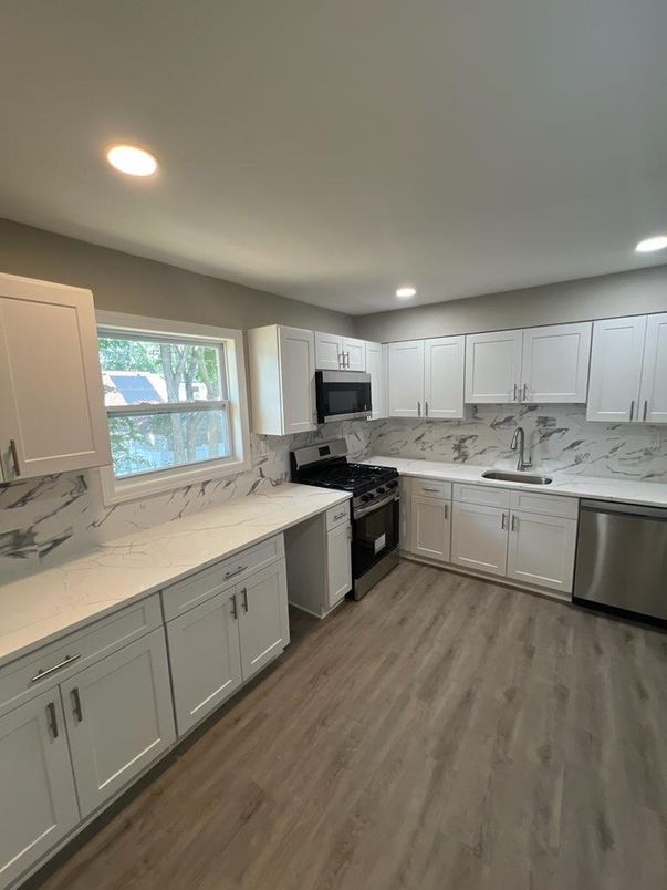 Interior, Kitchen, Marble Walls, Recessed Lighting, Stainless Steel Appliances, Wood Texture Flooring