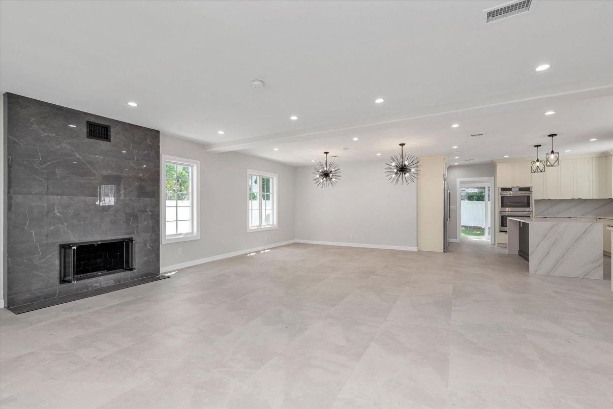 Chandelier, Empty room, Fireplace, Interior, Kitchen, Marble Walls, Pendant Lights, Recessed Lighting, Stainless Steel Appliances