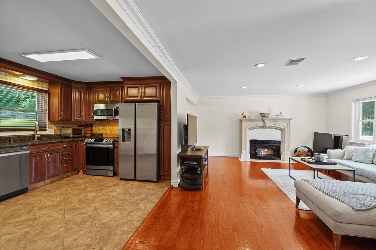 Fireplace, Interior, Kitchen, Living room, Recessed Lighting, Stainless Steel Appliances, Wood Texture Flooring