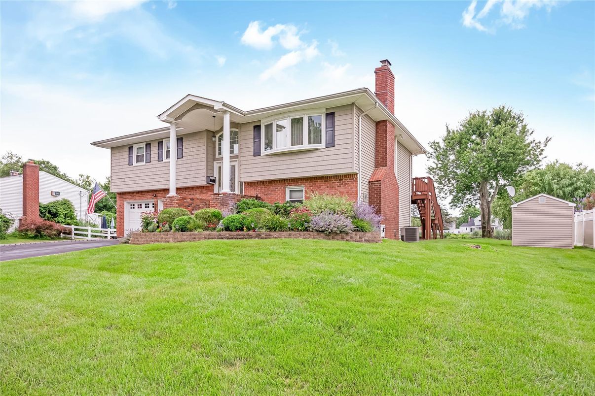 Attached, Backyard, Exterior, Facade, Brick Facade, Raised Ranch
