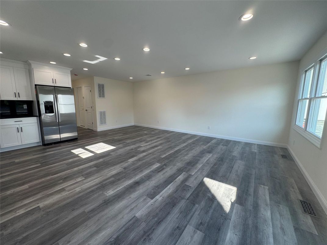 Empty room, Interior, Kitchen, Recessed Lighting, Stainless Steel Appliances, Wood Texture Flooring