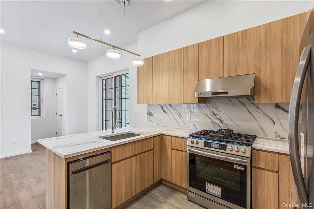 Interior, Kitchen, Marble Walls, Pendant Lights, Recessed Lighting, Stainless Steel Appliances, Wood Texture Flooring