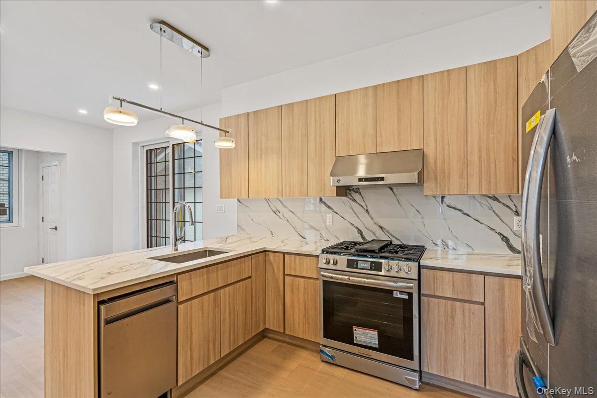 Interior, Kitchen, Marble Walls, Pendant Lights, Recessed Lighting, Stainless Steel Appliances, Wood Texture Flooring