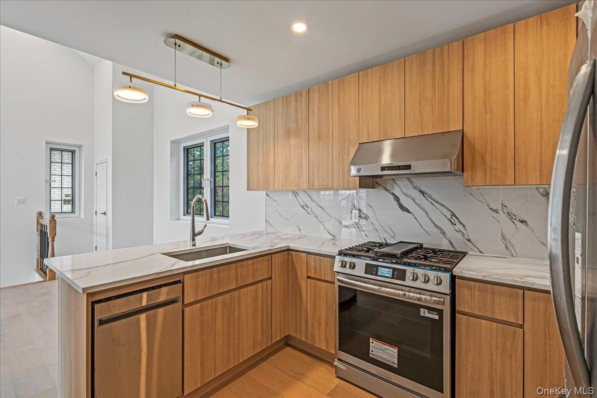 Interior, Kitchen, Marble Walls, Pendant Lights, Recessed Lighting, Stainless Steel Appliances, Wood Texture Flooring