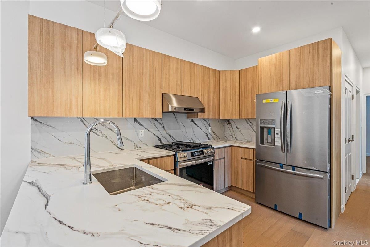 Interior, Kitchen, Marble Walls, Recessed Lighting, Stainless Steel Appliances, Wood Texture Flooring