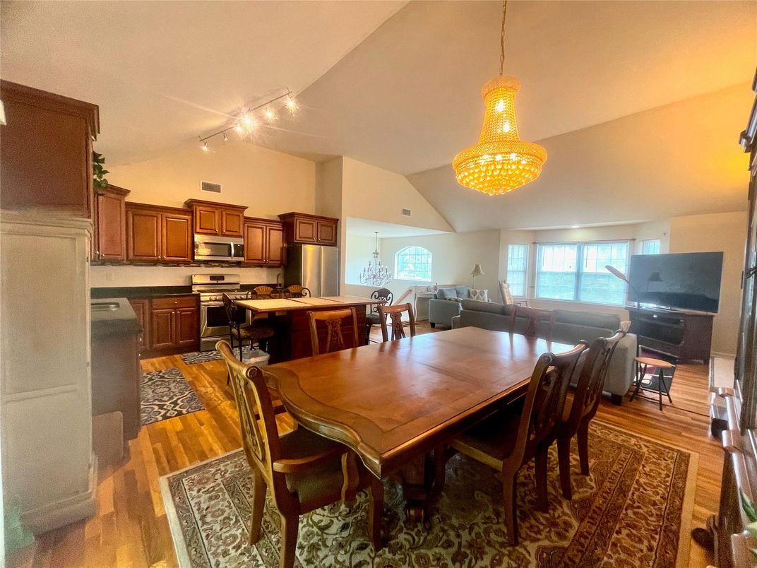 Chandelier, Dining room, Interior, Kitchen, Living room, Stainless Steel Appliances, Wood Texture Flooring