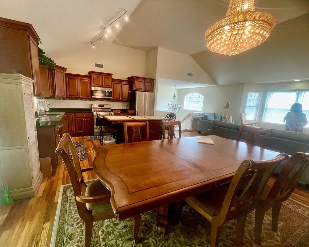 Chandelier, Dining room, Interior, Kitchen, Living room, Stainless Steel Appliances, Wood Texture Flooring