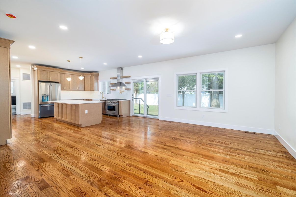 Empty room, Interior, Kitchen, Pendant Lights, Recessed Lighting, Stainless Steel Appliances, Wood Texture Flooring