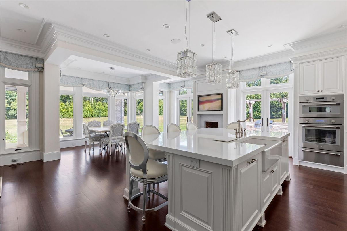 Chandelier, Dining room, Fireplace, Interior, Kitchen, Pendant Lights, Recessed Lighting, Stainless Steel Appliances, Wood Texture Flooring