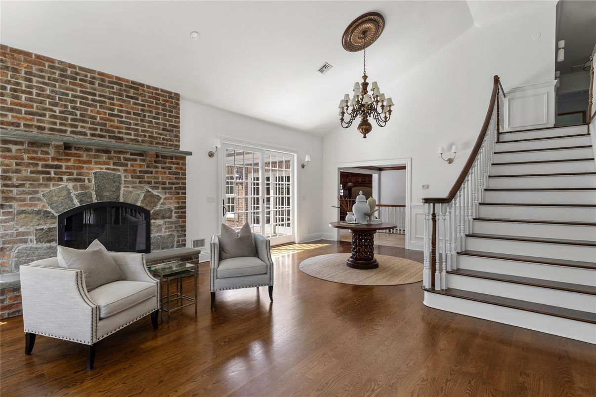 Chandelier, Fireplace, Interior, Recessed Lighting, Stone Walls, Wood Texture Flooring