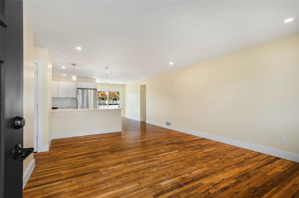 Empty room, Interior, Kitchen, Pendant Lights, Recessed Lighting, Stainless Steel Appliances, Wood Texture Flooring