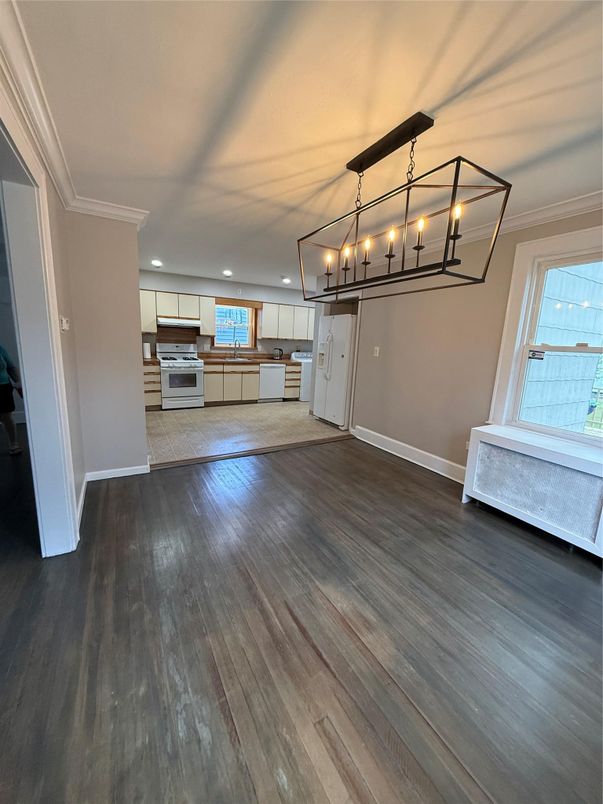 Chandelier, Empty room, Interior, Kitchen, Pendant Lights, Recessed Lighting, Stainless Steel Appliances, Wood Texture Flooring