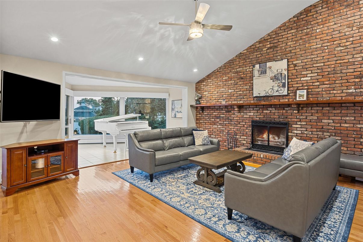 Fireplace, Interior, Living room, Piano, Recessed Lighting, Stone Walls, Wood Texture Flooring