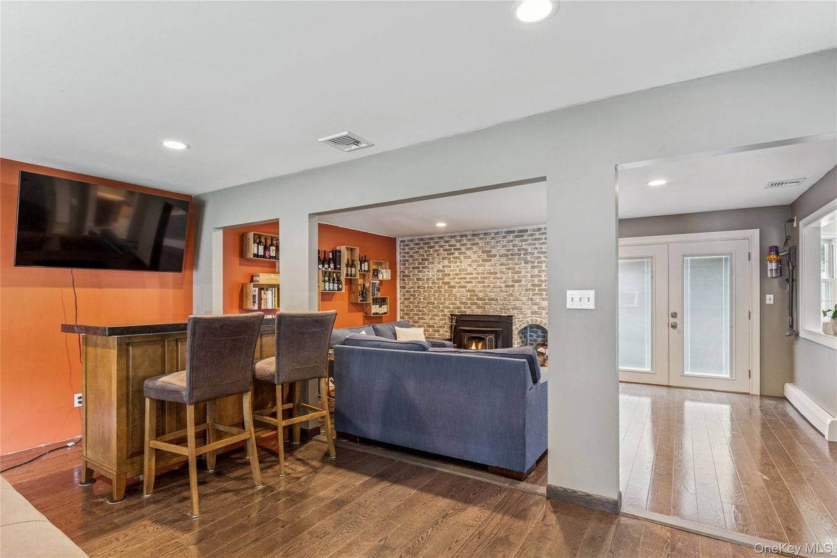Fireplace, Interior, Living room, Recessed Lighting, Stone Walls, Wood Texture Flooring