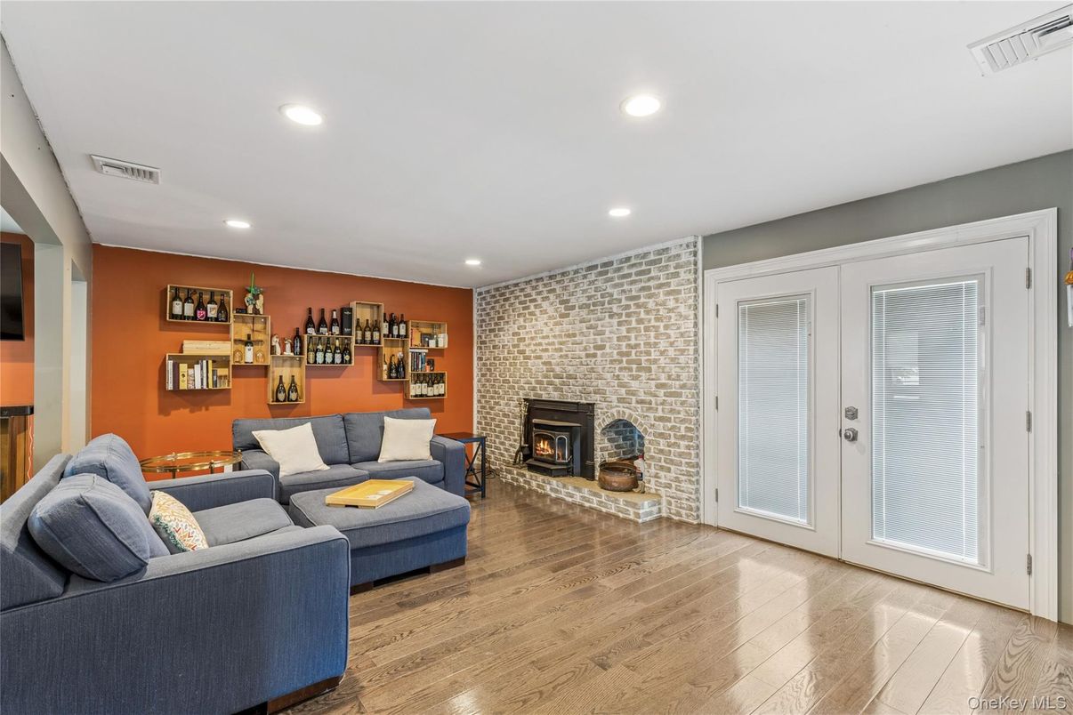 Fireplace, Interior, Living room, Recessed Lighting, Stone Walls, Wood Texture Flooring