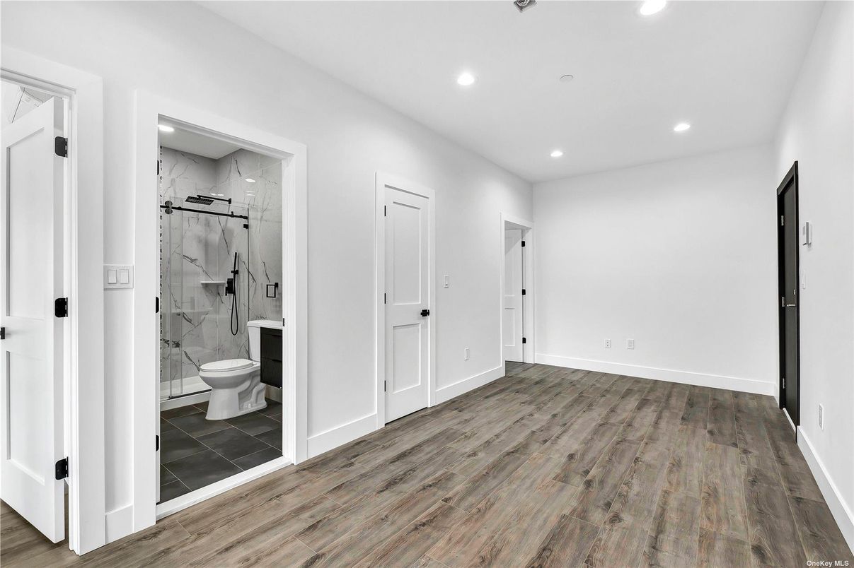 Bathroom, Glass Shower, Interior, Marble Walls, Recessed Lighting, Wood Texture Flooring