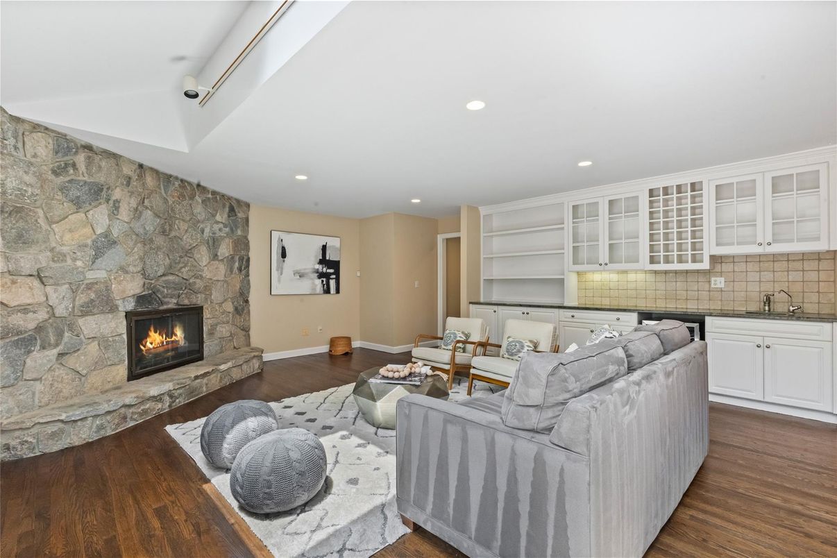 Fireplace, Interior, Living room, Recessed Lighting, Stone Walls, Wood Texture Flooring