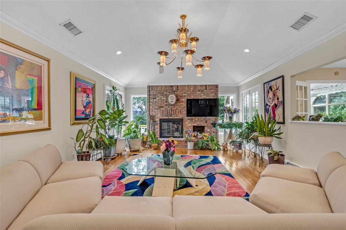 Chandelier, Fireplace, Interior, Living room, Recessed Lighting, Stone Walls, Wood Texture Flooring