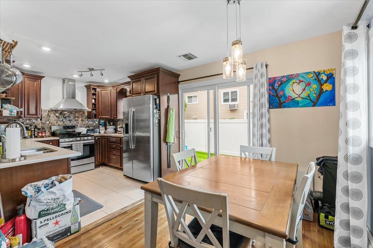Dining room, Interior, Kitchen, Pendant Lights, Recessed Lighting, Stainless Steel Appliances, Wood Texture Flooring