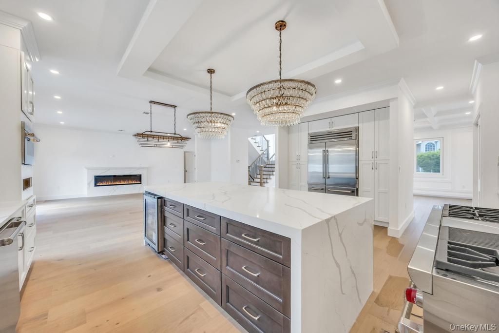 Chandelier, Fireplace, Interior, Kitchen, Pendant Lights, Recessed Lighting, Stainless Steel Appliances, Wood Texture Flooring