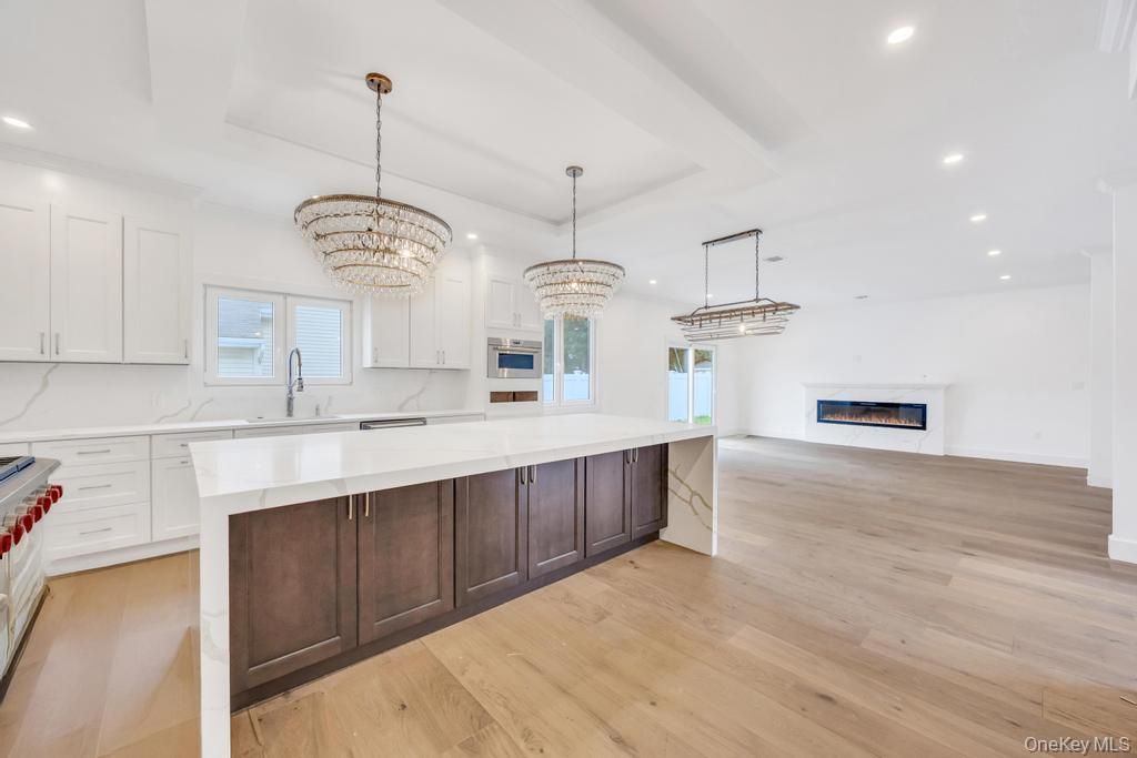 Chandelier, Fireplace, Interior, Kitchen, Marble Walls, Pendant Lights, Recessed Lighting, Wood Texture Flooring