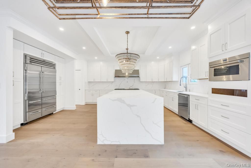 Chandelier, Interior, Kitchen, Marble Walls, Recessed Lighting, Stainless Steel Appliances, Wood Texture Flooring