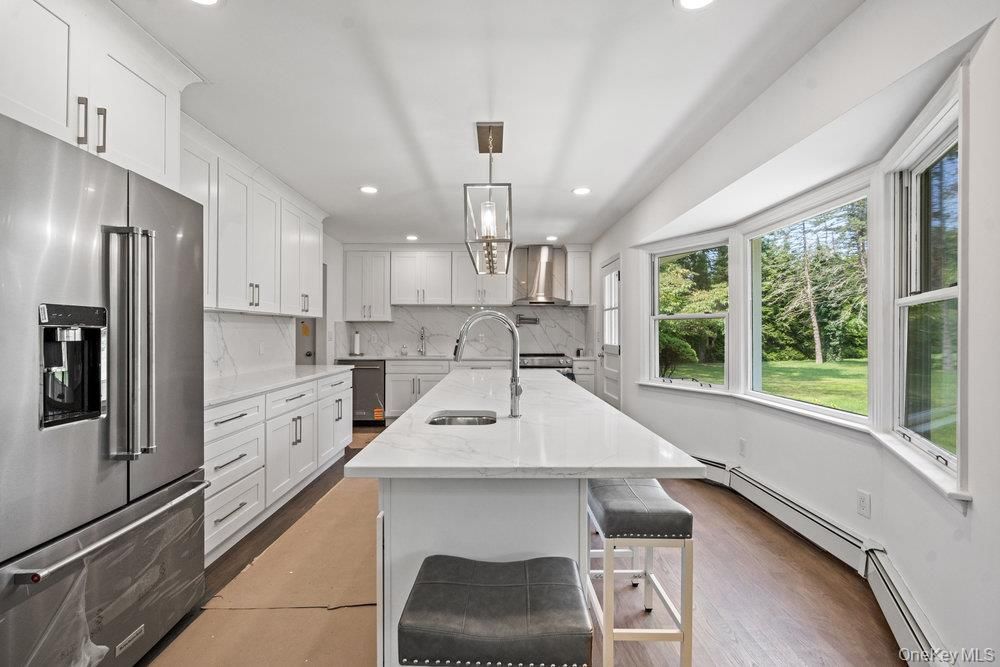 Interior, Kitchen, Marble Walls, Pendant Lights, Recessed Lighting, Stainless Steel Appliances, Wood Texture Flooring