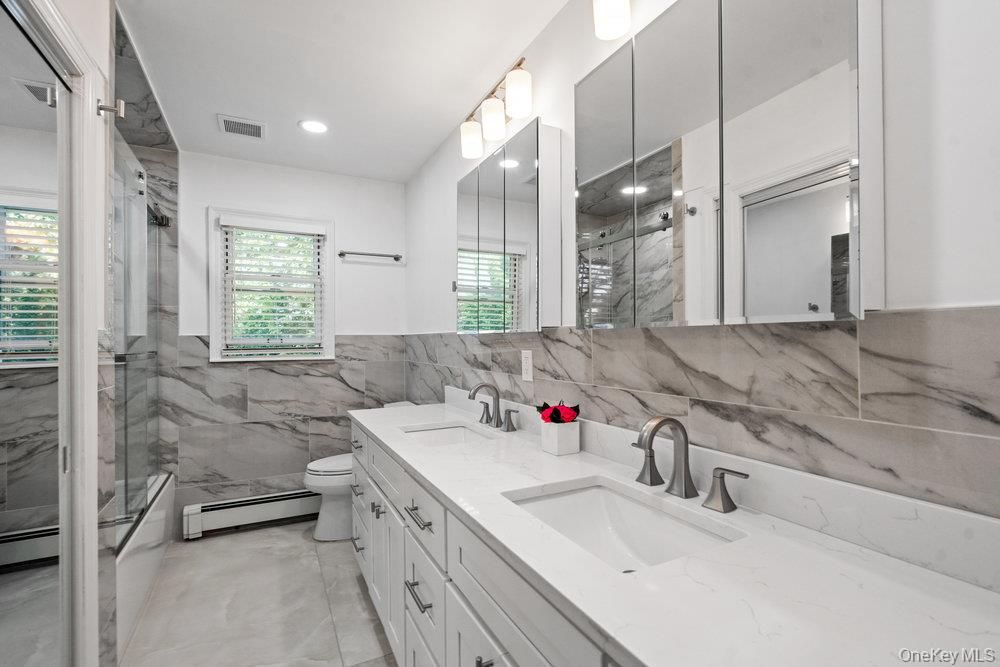 Bathroom, Dual Sink Vanities, Glass Shower, Interior, Marble Walls, Recessed Lighting