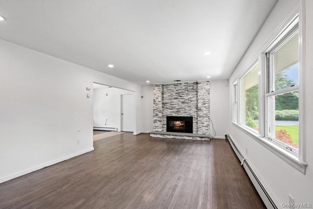 Empty room, Fireplace, Interior, Recessed Lighting, Stone Walls, Wood Texture Flooring