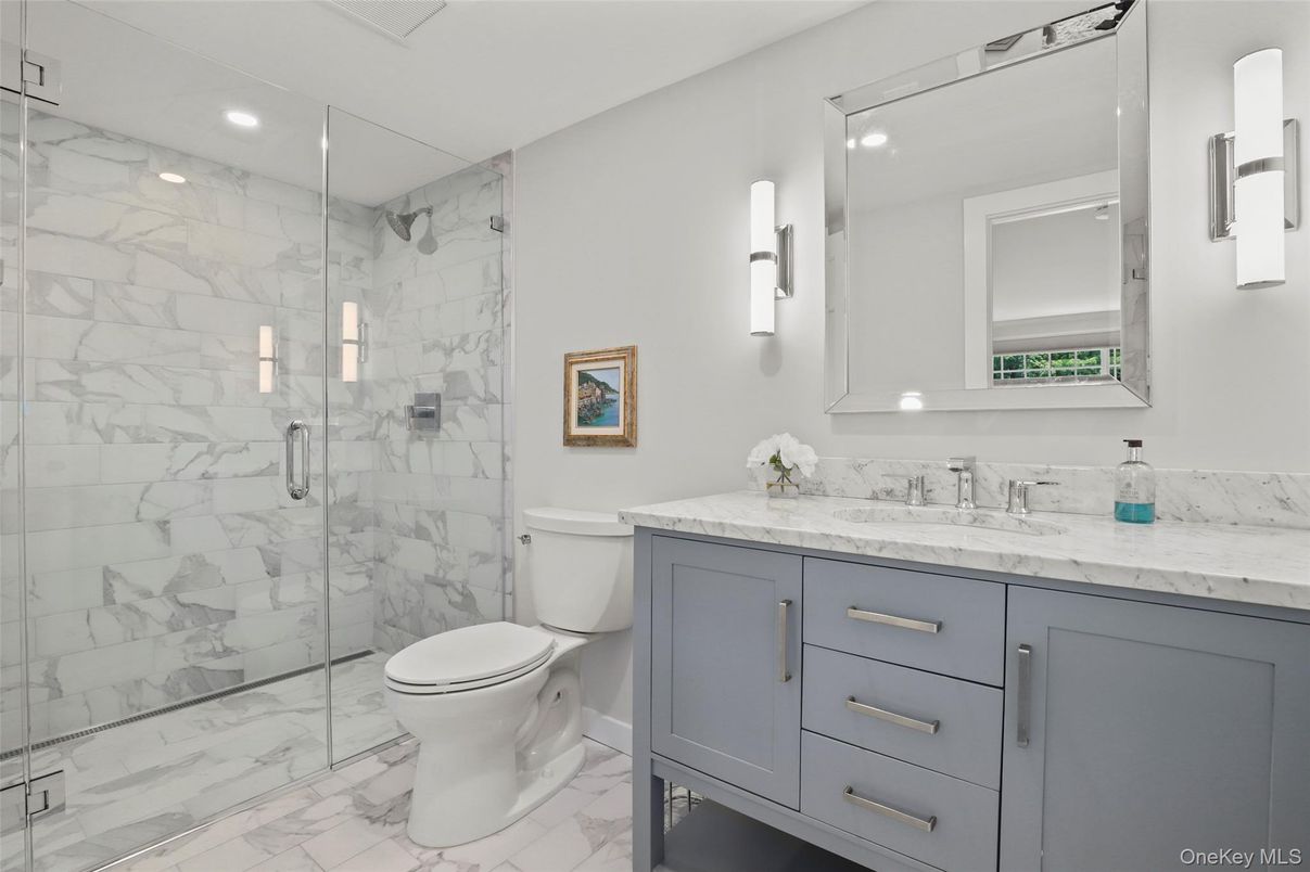 Bathroom, Dual Sink Vanities, Glass Shower, Interior, Marble, Marble Walls, Recessed Lighting