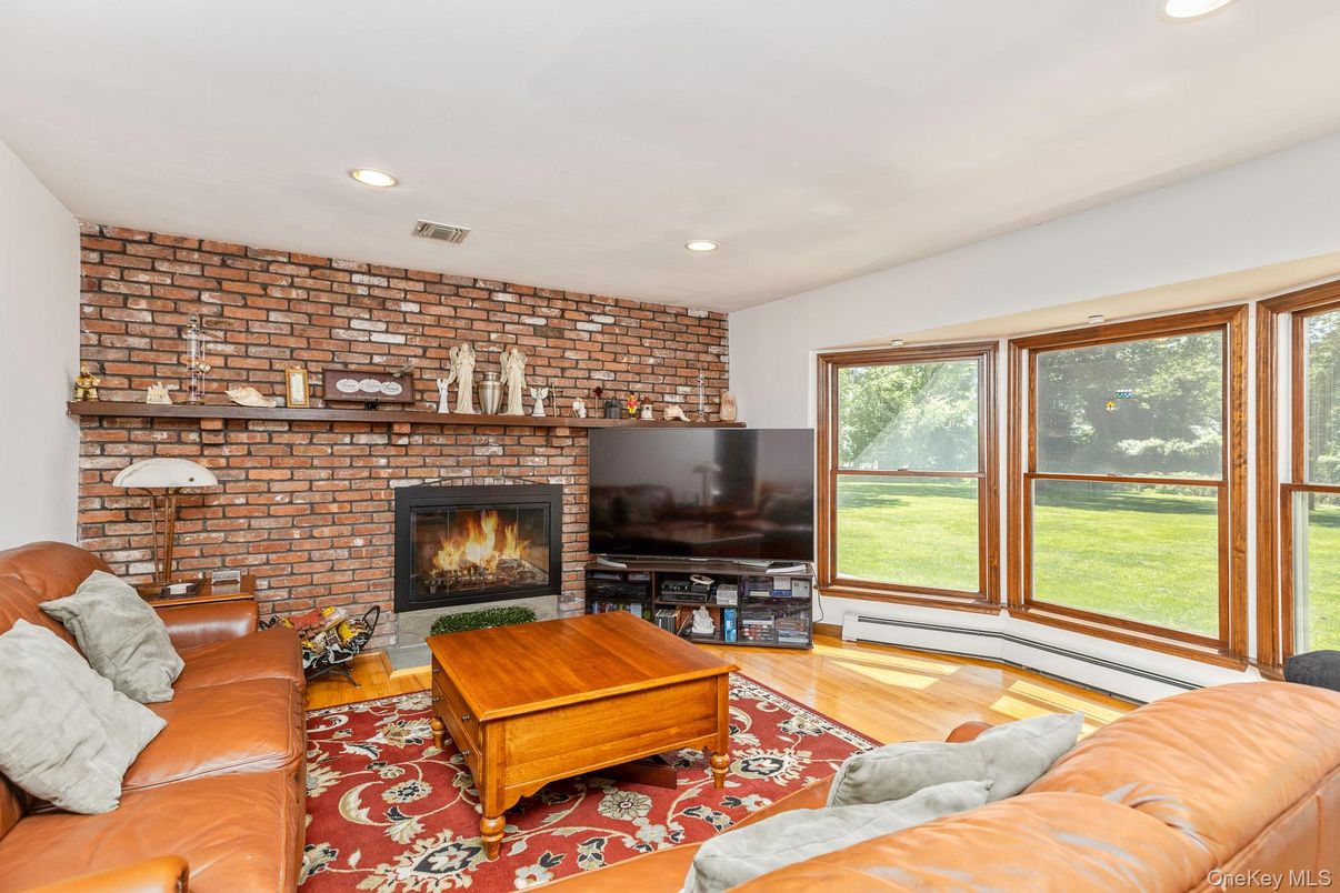 Fireplace, Interior, Living room, Recessed Lighting, Stone Walls, Wood Texture Flooring
