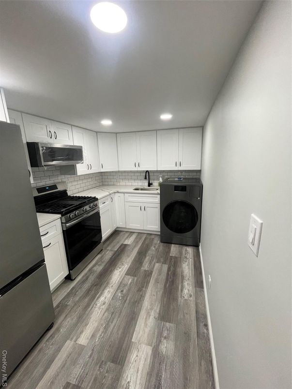 Interior, Kitchen, Recessed Lighting, Washer, Wood Texture Flooring