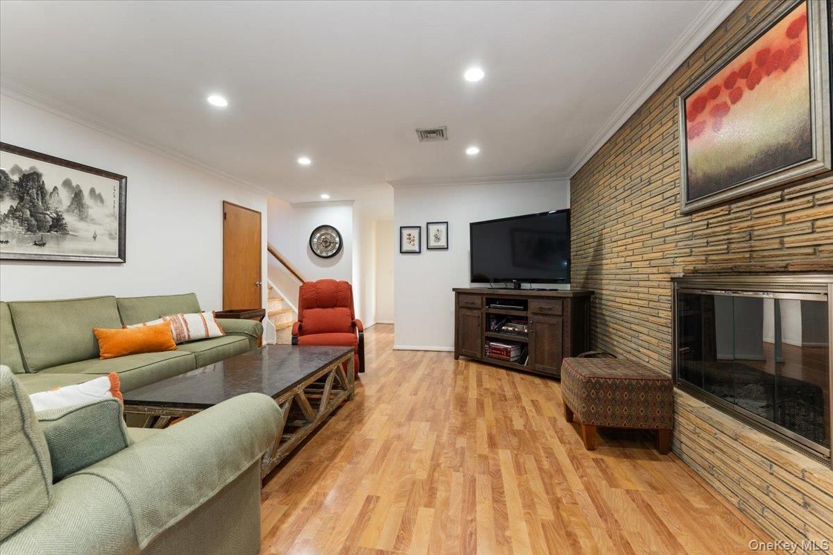 Fireplace, Interior, Living room, Recessed Lighting, Stone Walls, Wood Texture Flooring