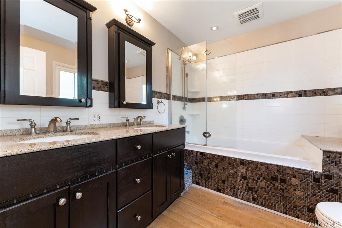 Bathroom, Dual Sink Vanities, Glass Shower, Interior, Recessed Lighting, Wood Texture Flooring